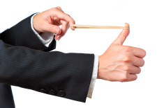 stock-photo-9459899-a-businessman-aiming-a-rubber-band-on-a-white-background.jpg